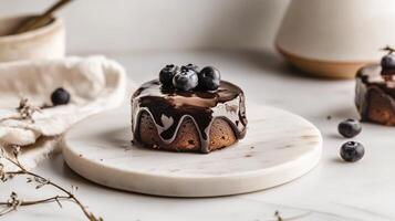 A small cake with chocolate frosting on top photo