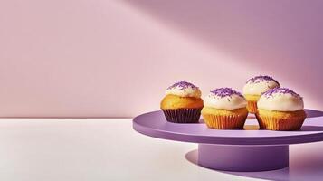 Four cupcakes on a purple plate with purple frosting photo