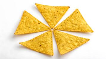 Triangular corn chips arranged in circular pattern perfect for snack time and party themes. photo