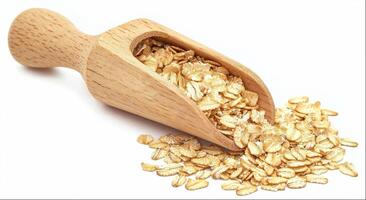 Oatmeal flakes in wooden scoop isolated on white background photo