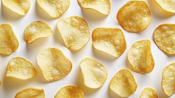 Golden potato chips arranged in a pattern, top view texture photo