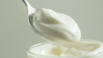Spoonful of creamy yogurt isolated on white background with copy space photo