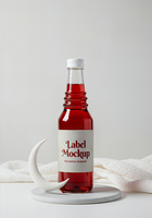 A Ramadan Mubarak label mockup on a bottle of red liquid displayed with a crescent moon psd