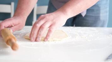 man rolling dough with rolling pin in the home kitchen video