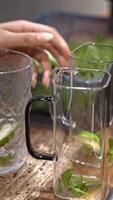 Refreshing cocktail with lime slice, bartender adding lime, close-up fresh ingredients, creating vibrant summer drink, symbol of creativity and seasonal freshness, vertical footage. video