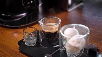 Espresso with creamy ice cream, served in transparent glassware in form of skull, contrast of heat and chill, elegant presentation of dessert coffee in gloomy style, Turkey, Alanya, July 16, 2024. video