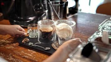 Coffee preparation with cream ice cream, blending flavors of richness and indulgence, barista artistry in creating xperfect dessert drink, process of serving on tray, Turkey. Alanya, July 16, 2024. video