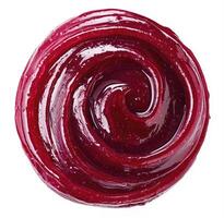 Swirl of berry jam isolated on white background, top view photo
