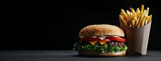 Beef burger and french fries, close-up shot, black background with copy space photo