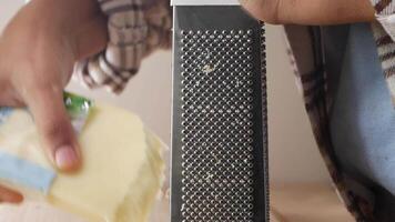 Grating cheese for a delicious meal preparation at home video