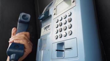 Using a public payphone to make a call in the city video