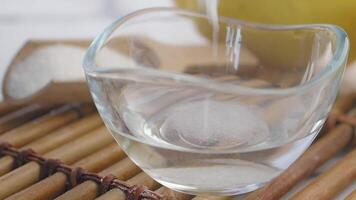 mixing baking soda with a water and slice of lemon on a table video