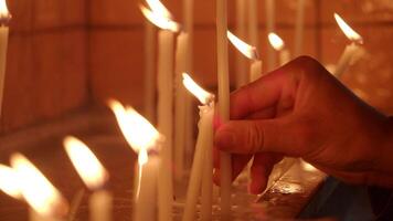 Lighting candles for prayer in a serene setting video