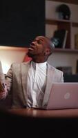 African American male Lawyer Presenting Case. Attorney Protecting Client Innocents with Supporting Argument using a laptop, computer in office setting with scales of justice on the desk. Vertical video