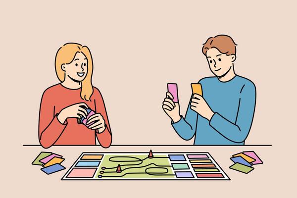 Happy couple playing board game while spending free time together and having fun after working day