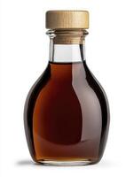 A bottle of maple syrup with a wooden lid photo