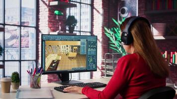 Woman arranging virtual assets in a architectural software on dual monitors, creating a detailed 3D render of a floor plan. Freelancer uses program for computer aided interior design. Camera B. video