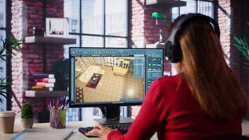 Professional architectural designer configures a floor plan on dual monitors, utilizing computer aided design tools. Woman uses digital rendering and interior decoration remodeling. Camera B. video