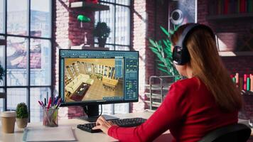 Woman at home creating a 3D render of an apartment interior layout, utilizing architectural software. Developer uses digital tools to decorate detailed home design, placing assets. Camera B. video