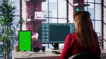 Freelancer interacting with smart AI virtual assistant next to mockup screen, using innovative chatbot web interface. Machine learning enhances productivity through advanced algorithms. Camera B. video