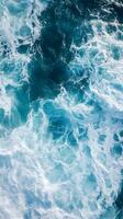 An aerial view of the ocean with waves photo