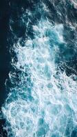 An aerial view of the ocean with waves photo