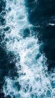 An aerial view of the ocean with waves photo
