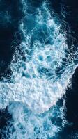An aerial view of the ocean with waves photo