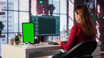 Freelancer interacting with smart AI virtual assistant next to mockup screen, using innovative chatbot web interface. Machine learning enhances productivity through advanced algorithms. Camera A. video