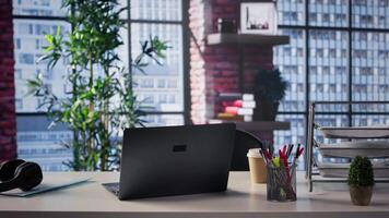 High end home office in a trendy loft apartment with an empty desk. Sleek neutral design and artistic details create a refined comfortable workspace with an upscale, creative feel. video