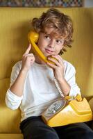 Content child having conversation on retro phone photo