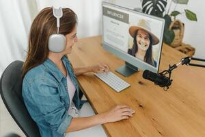 Radio host recording podcast and using computer photo