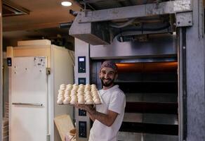 Arabic baker with tray with dough balls photo
