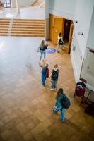 Unrecognizable students going to studies in hall photo