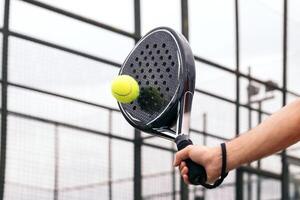 paddle tennis racket hitting ball. close- up on the racket photo