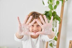 Happy boy showing soapy palms in camera photo