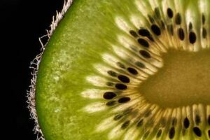 Fresh kiwi fruit texture on black background photo