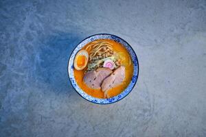 Delicious noodle soup with pork meat and egg in bowl photo