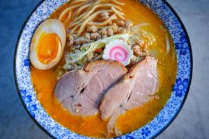 Bowl of delicious pork soup served on table photo