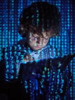 Hacker boy using digital tablet photo