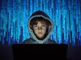 Hacker looking at camera at computer photo