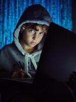 Boy using laptop on binary code background photo