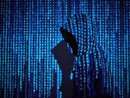 Coder standing on background of computer symbols photo