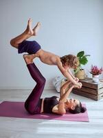 Mother and son taking acro yoga pose photo