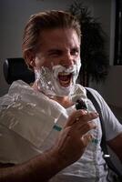 Man with foamy beard pretending to sing photo