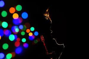 Anonymous kid blowing bubbles in darkness photo