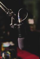 Modern microphone in dark studio photo