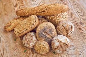 Pile of bread on wooden table photo