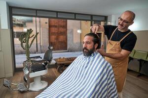 Barber combing hair of client in salon photo