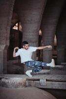 Skillful b boy showing technique in aged cathedral photo